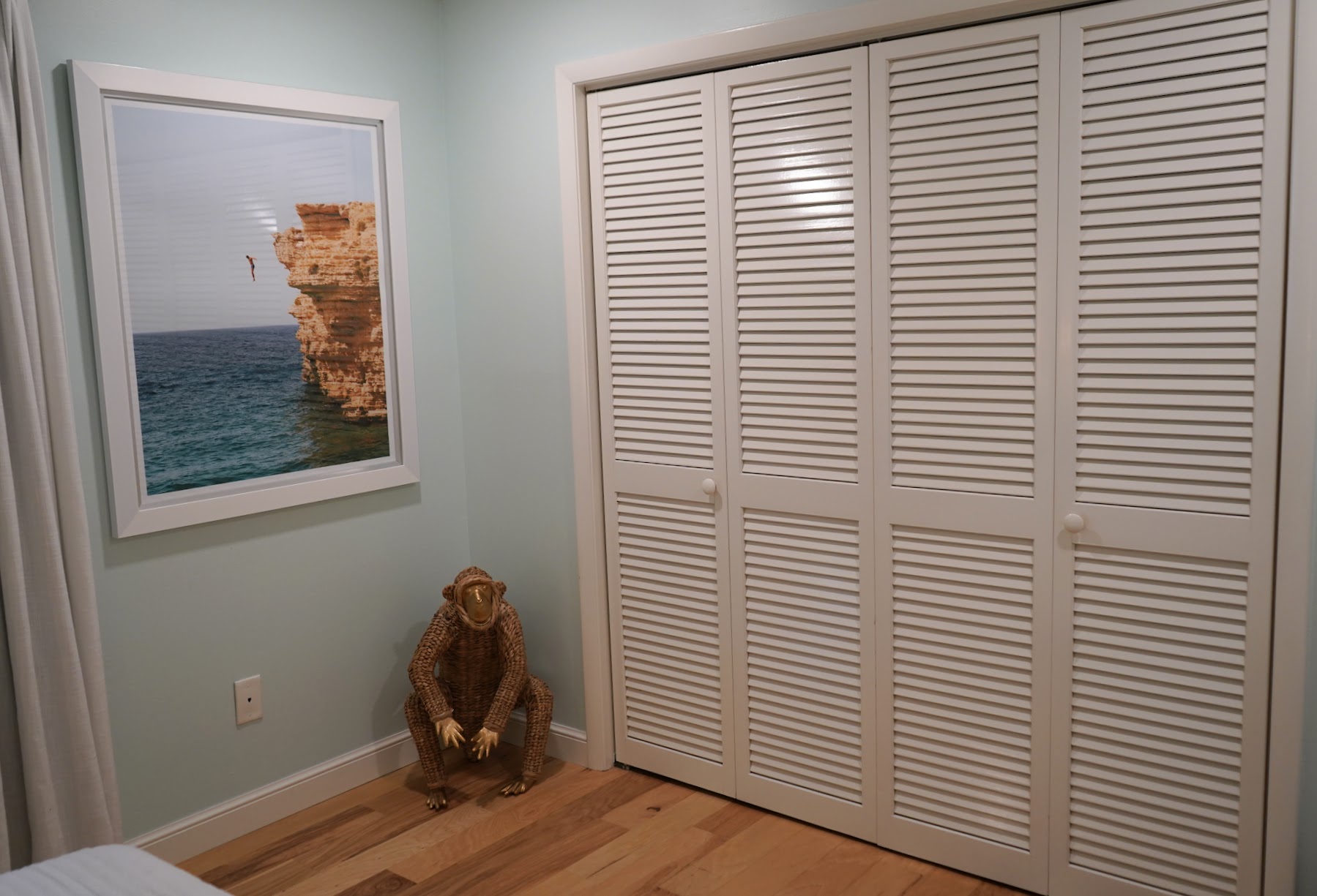 Bedroom storage and coastal artwork