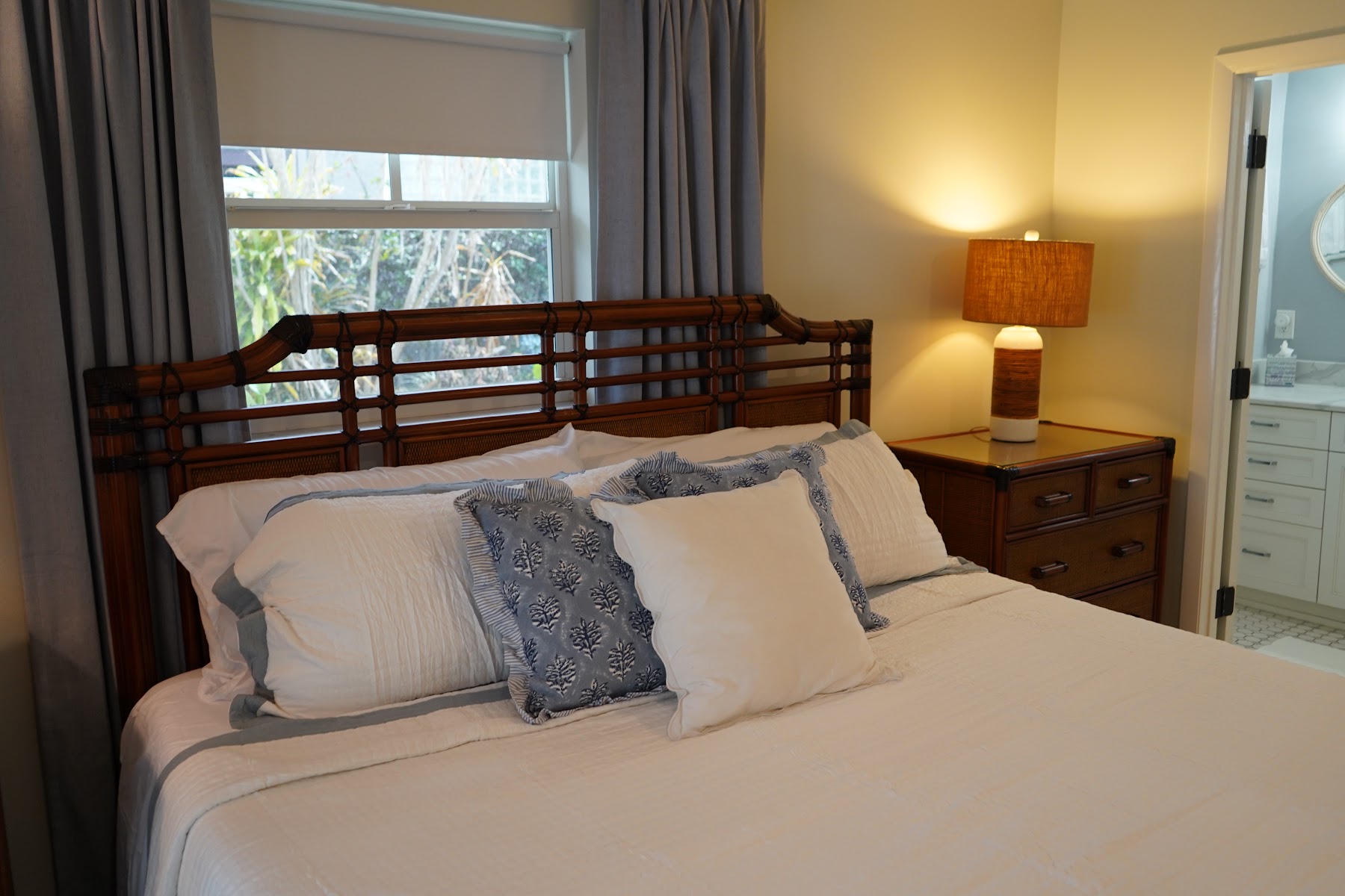 Primary bedroom with layered coastal bedding